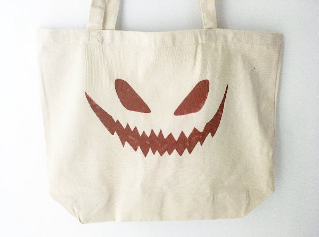 Jack-o-lantern face over sized canvas tote